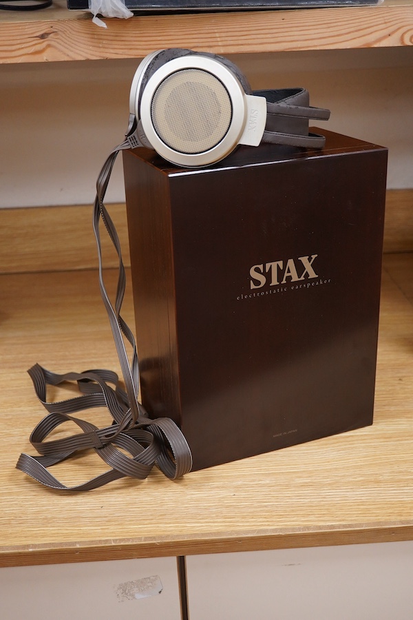 A pair of over-ear Japanese Stax Electrostatic earspeakers, SR-009S, contained within the original wooden box, with outer packaging, owners manual, etc. together with the Stax driver unit for earspeakers with vacuum tube